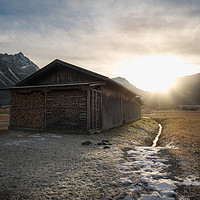 Buy canvas prints of Barn with firewood at sunset in the Alps by Daniela Simona Temneanu