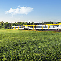 Buy canvas prints of German passenger train in motion. Yellow electric train traveling by Daniela Simona Temneanu