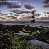 Buy canvas prints of Dramatic Sunset Over Trwyn Du Lighthouse by Derek Daniel