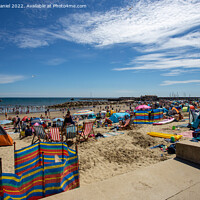 Buy canvas prints of The Vibrant Scene of Lyme Regis Beach by Derek Daniel