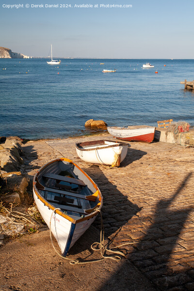boats on the slipway at Swanage Picture Board by Derek Daniel