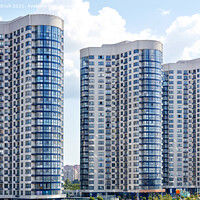 Buy canvas prints of Tall houses of white-blue high-rise buildings in a new district of the city. by Sergii Petruk