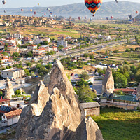 Buy canvas prints of Dozens of balloons fly over the city of Goreme in Turkey and over the valleys of Cappadocia. by Sergii Petruk