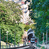 Buy canvas prints of Funicular rail track, the car is filled with passengers at the lower station, surrounded by a summer green park. by Sergii Petruk