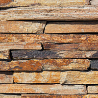 Buy canvas prints of Brown slabs of old sandstone are lined with a wall. by Sergii Petruk