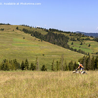 Buy canvas prints of Motorcyclist moves down the slope of the Carpathian Mountains by Sergii Petruk