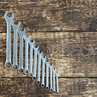 Buy canvas prints of set of wrench against old wooden boards background by Sergii Petruk