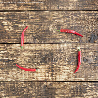 Buy canvas prints of hot red peppers chili on an old wooden background by Sergii Petruk
