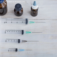 Buy canvas prints of Syringes and capsules, medical ampoules on a white wooden table. by Sergii Petruk