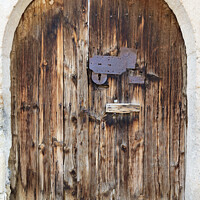 Buy canvas prints of Ancient arched antique wooden doors with a metal lock in the middle by Sergii Petruk