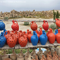 Buy canvas prints of The multi-colored clay pots of desires stand on a wooden table in Cappadocia. by Sergii Petruk