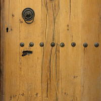Buy canvas prints of old wooden door with wrought iron rivets by Sergii Petruk