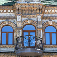 Buy canvas prints of The wooden windows of the old architecture building reflect the blue clear sky by Sergii Petruk