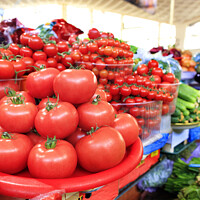 Buy canvas prints of Tomatoes, cucumbers, spinach and other vegetables are sold on the market. by Sergii Petruk