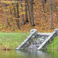 Buy canvas prints of In the autumn pond down the stone old steps. by Sergii Petruk