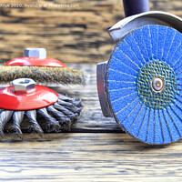 Buy canvas prints of Angle grinder with grinding disc brushes lies on the background of a wooden table. by Sergii Petruk