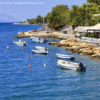 Buy canvas prints of Powerboats and boats are anchored along the rocky coast of the Ionian Sea. by Sergii Petruk