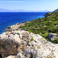 Buy canvas prints of The coastline of the Ionian Sea is dotted with large stone boulders. by Sergii Petruk