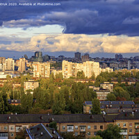 Buy canvas prints of The beautiful light of the setting sun falls on the houses in the city landscape. by Sergii Petruk