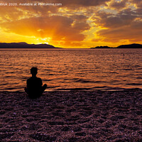Buy canvas prints of Silhouette of a teenager who sits on a pebble sea shore and watches a beautiful, vibrant sunset on the Gulf of Corinth in Greece. by Sergii Petruk