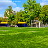 Buy canvas prints of Green lawn of a soccer field with gates and tents for teams players. by Sergii Petruk