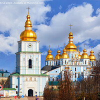 Buy canvas prints of The famous Mikhailivsky Golden-Domed Cathedral and the bell tower in Kyiv in early spring against a blue cloudy sky. by Sergii Petruk