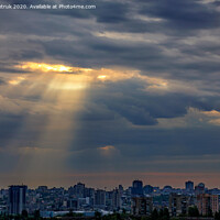 Buy canvas prints of The sun's rays break through dense clouds at dawn over the city. by Sergii Petruk