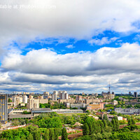 Buy canvas prints of Panorama of cityscape with big low clouds and bright sunlight. by Sergii Petruk