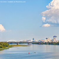 Buy canvas prints of A large figured cloud hung over the city near the railway bridge near the Dnipro River. by Sergii Petruk