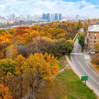 Buy canvas prints of Bright orange foliage of the city park in the autumn landscape of the city, view from the top. by Sergii Petruk