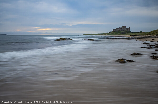 Bamburgh castle beach waves northumberland Picture Board by david siggens