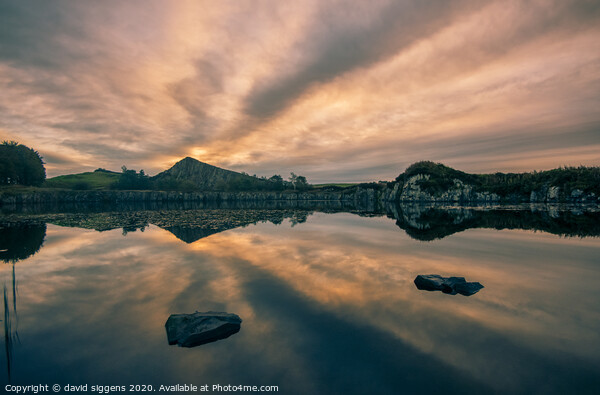 Cawfields Quarry rising sun fire Picture Board by david siggens
