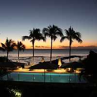 Buy canvas prints of Mauritian sunset by the pool lined with palm trees by Carmen Green