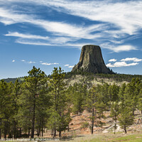 Buy canvas prints of Devils Tower with fair weather clouds above by Peter Scott