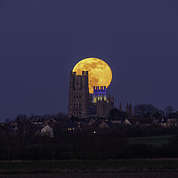 Buy canvas prints of Worm Moon rising behind Ely Cathedral, 18th March 2022 by Andrew Sharpe