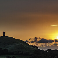 Buy canvas prints of Dawn behind Glastonbury Tor by Andrew Sharpe