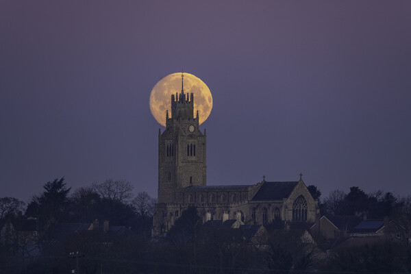Snow Moon (or Hunger Moon) setting behind St Andrew's Church, Su Picture Board by Andrew Sharpe