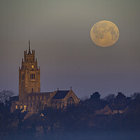Buy canvas prints of Snow Moon (or Hunger Moon) setting behind St Andrew's Church, Su by Andrew Sharpe