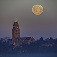 Buy canvas prints of Snow Moon (or Hunger Moon) setting behind St Andrew's Church, Su by Andrew Sharpe