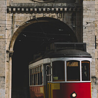 Buy canvas prints of Traditional yellow Lisbon Tram in front of Se Cathedral  by Alexandre Rotenberg