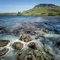 Buy canvas prints of Rocks on the shore of Llynnau Cregennen lake by Tom Radford