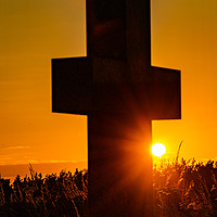 Buy canvas prints of A cross at sunset by John Stoves