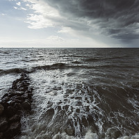 Buy canvas prints of Rocks in the sea with storm sky on the beach by Juan Ramón Ramos Rivero