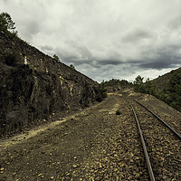 Buy canvas prints of Old train tracks between mountains on a cloudy day by Juan Ramón Ramos Rivero