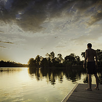 Buy canvas prints of Man standing without shirt looking the sunset by Juan Ramón Ramos Rivero