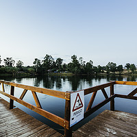 Buy canvas prints of Wooden jetty with danger sign jumping into the wat by Juan Ramón Ramos Rivero