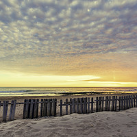 Buy canvas prints of Fence on sand beach at sunset in Chipiona by Juan Ramón Ramos Rivero