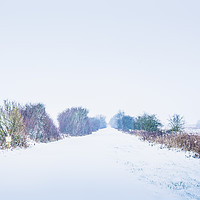 Buy canvas prints of Looking down a Railway line in a Blizzard by James Aston