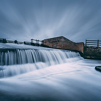 Buy canvas prints of Slow Moving Water over the Weir by James Aston