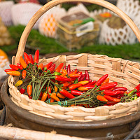 Buy canvas prints of Red hot chillies in a basket by Andrew Michael